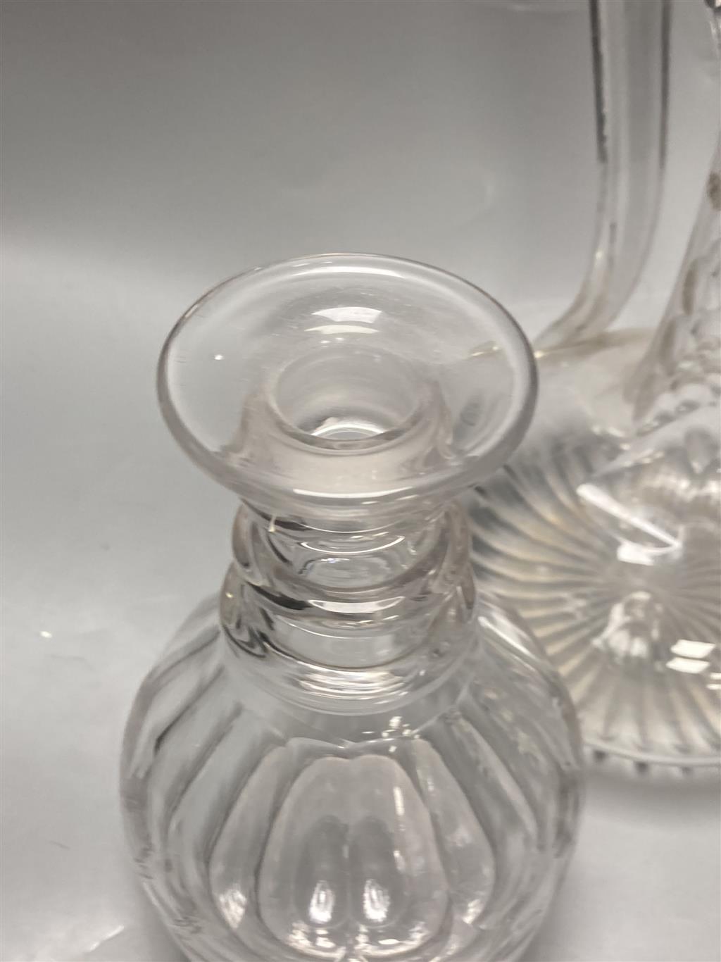 A pair of early 19th century cut glass decanters, height 24cm and an Edwardian claret jug, height 30cm (one decanter a.f.)